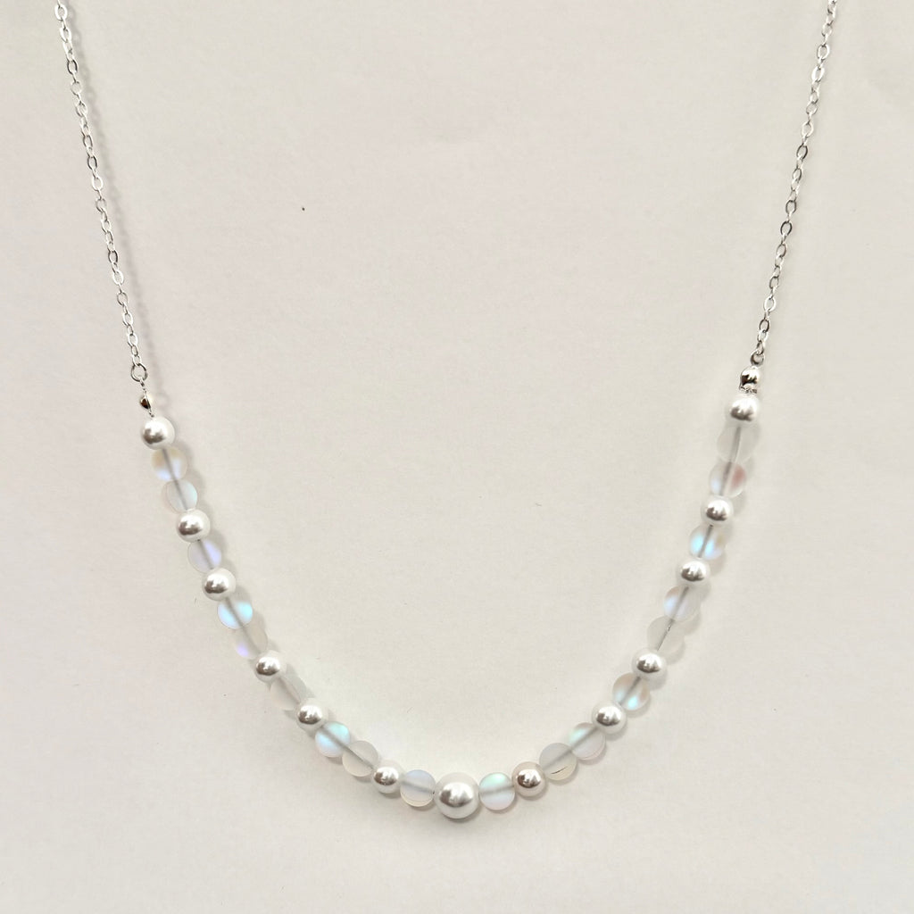 Necklace with small beads on a light gray background
