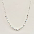 Necklace with small beads on a light gray background