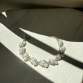 Pearl Bracelet on a textured surface with sunlight casting shadows