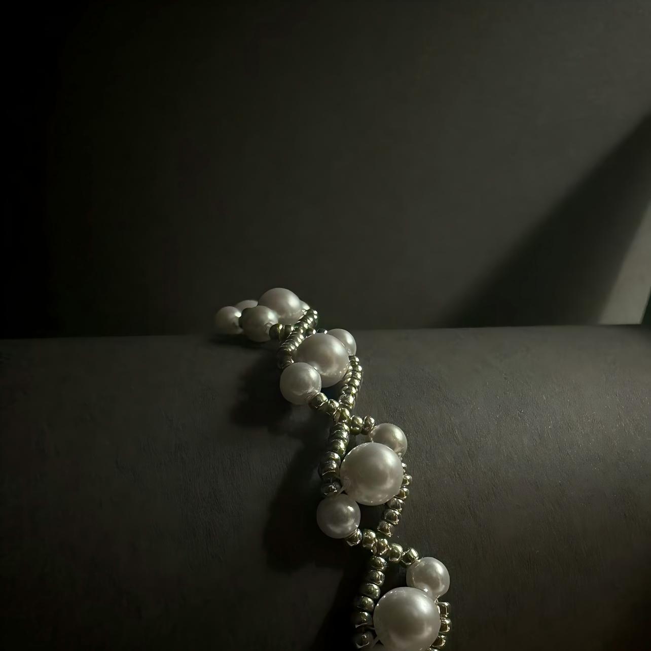 Detail look of Pearl bracelet on a dark surface with a dark background