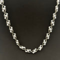 Silver beaded necklace on a black background